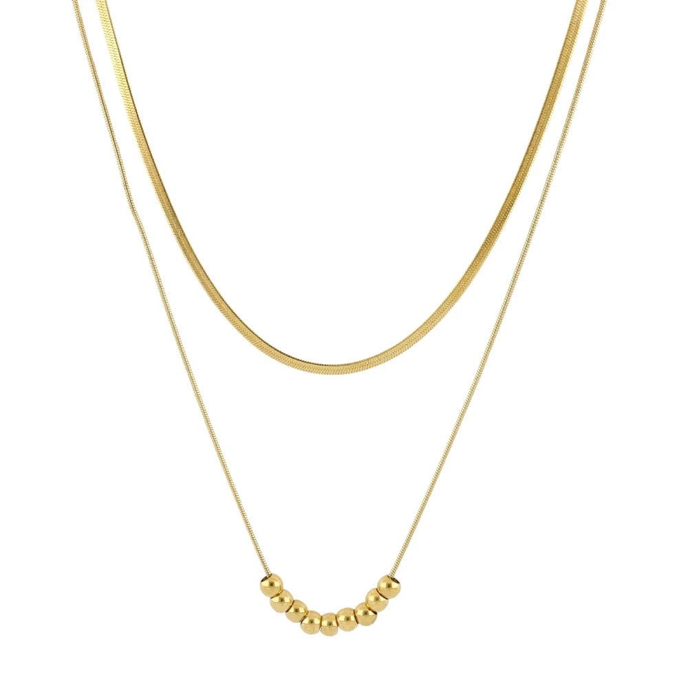 Collar doble Aura en acero dorado con detalle de bolitas