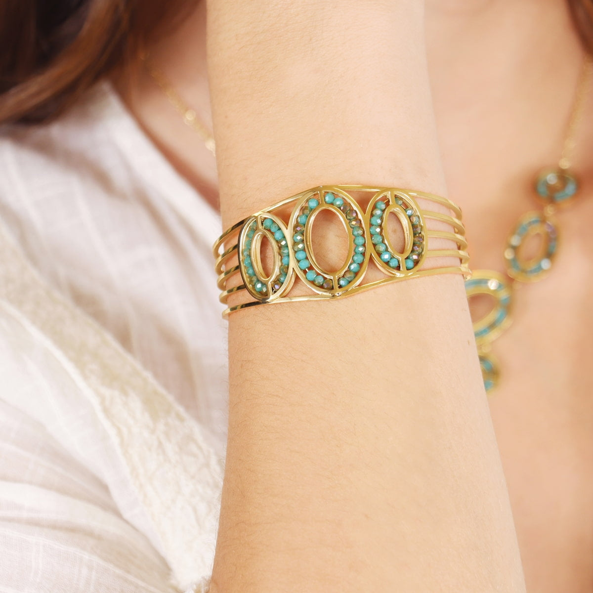 Pulsera Levity Calm dorada con piedras de cristal turquesa en modelo