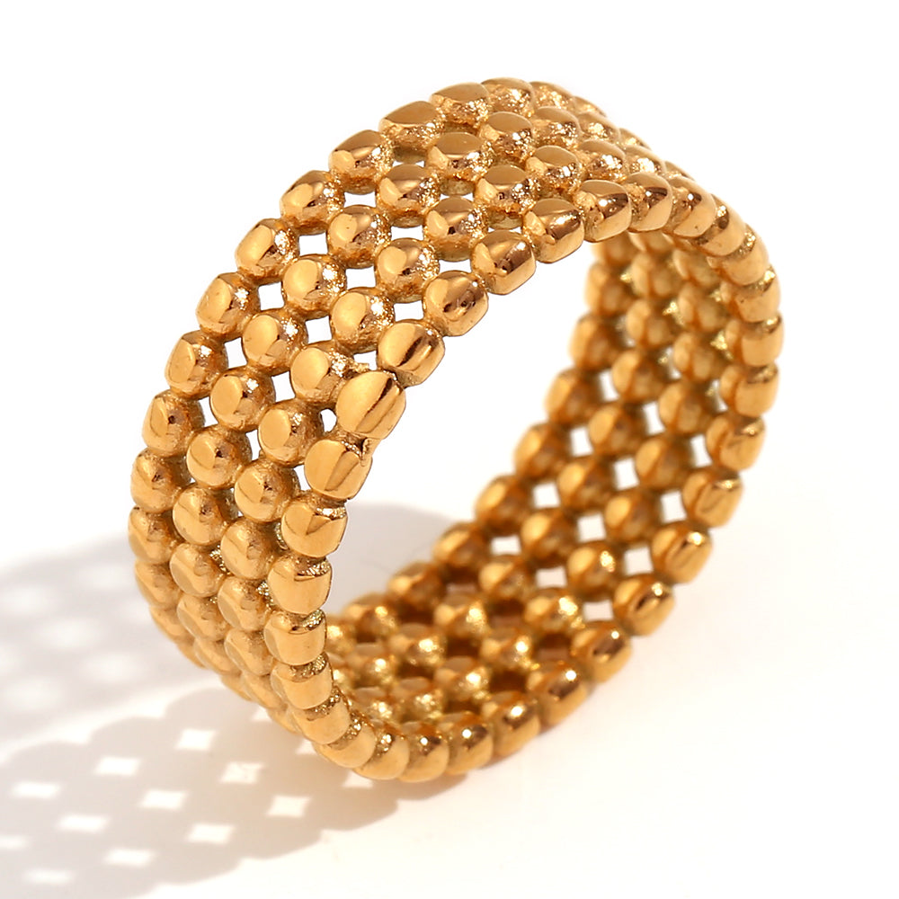 Anillo Bubble ancho de acero con bolitas en acabado dorado, diseño con volumen y textura