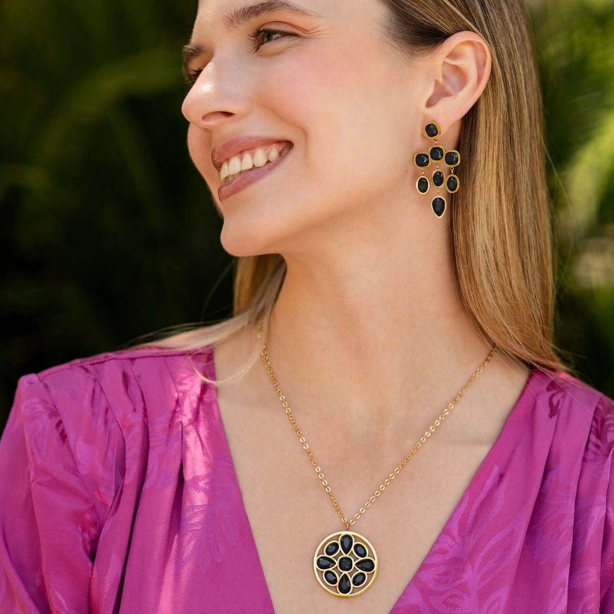 Modelo con pendientes de cristales negros y base dorada
