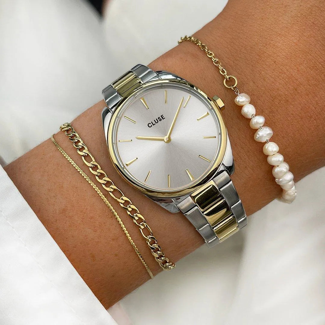 Detalle del reloj Cluse Féroce Petite bicolor oro y plata, esfera y correa metálica